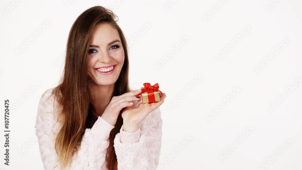 Woman holds present little golden gift box with red ribbon 4K Woman holds present little golden gift box with red ribbon 4K