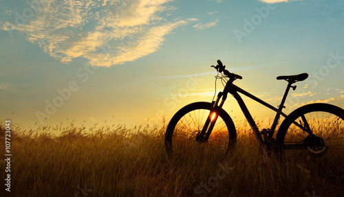 Silhouette Mountain biking, down hill at sunset