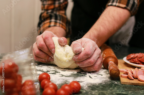 man hand prepare pizza dough topping
