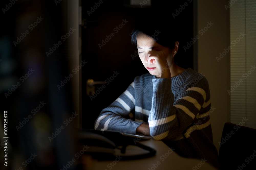 Woman suffer from eye problem when using tablet pc Woman suffer from eye problem when using tablet pc