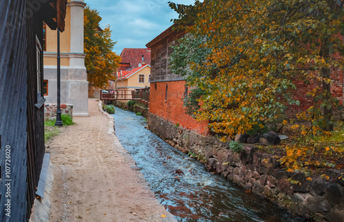 Brook among medieval buildings in Kuldiga town, Latvia, Europe