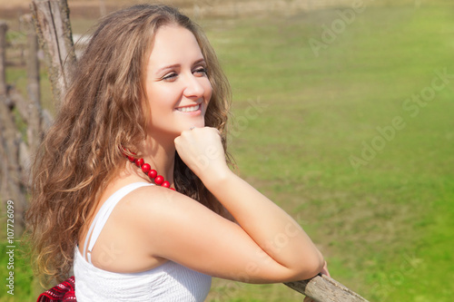 Portrait of a beautiful young woman outdoors in the summer