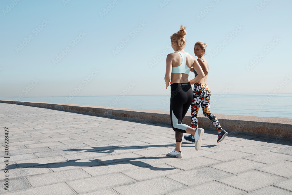 Two female runners exercising outdoors 