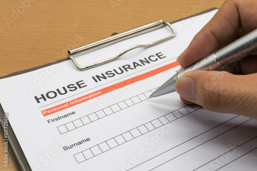 man signing a house insurance policy