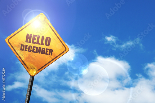 Yellow road sign with a blue sky and white clouds: hello decembe photo