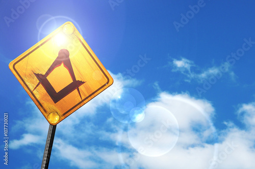 Photos Yellow road sign with a blue sky and white clouds: Masonic freem