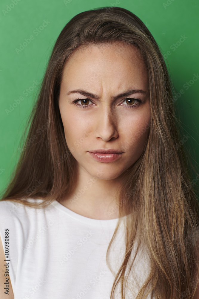 Beautiful brunette frowning at camera