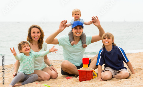 Happy family of five at sea shore
