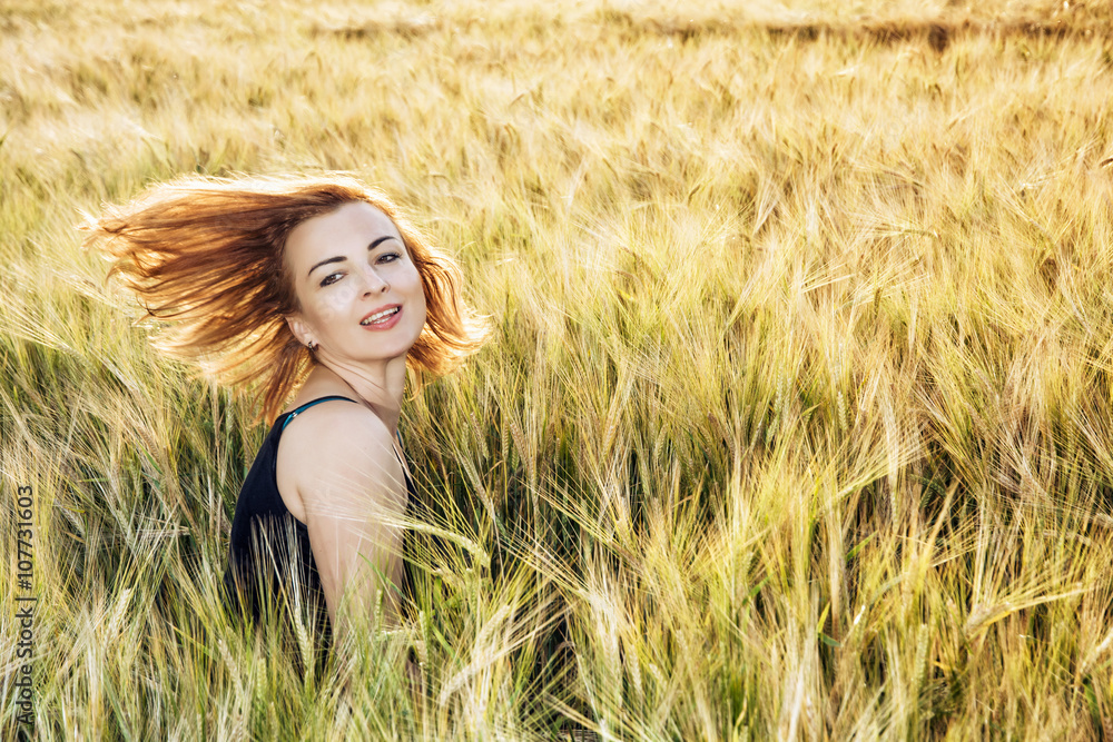 Young caucasian brunette throws her hair in wheat field Young caucasian brunette throws her hair in wheat field