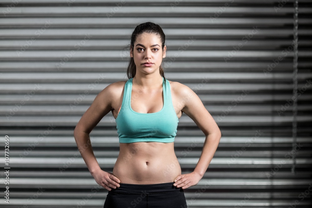 Naklejka premium Portrait of fit woman with hands on hips