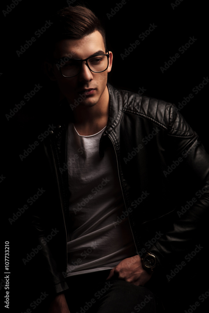 Obraz premium dark haired man in leather wearing frames, resting