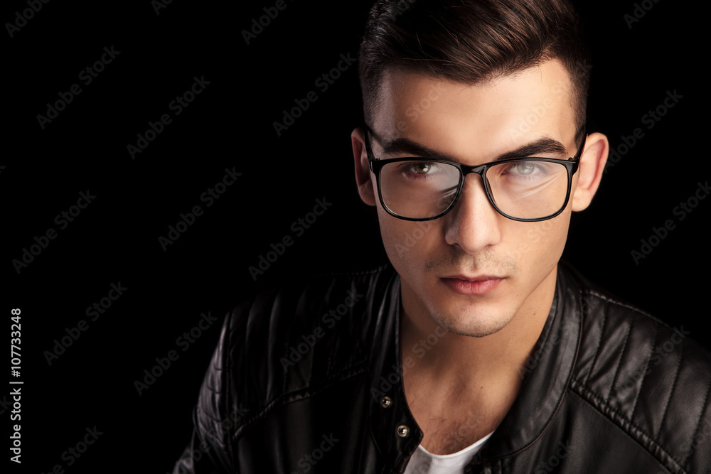 closeup shaved macho in black leather wearing glasses