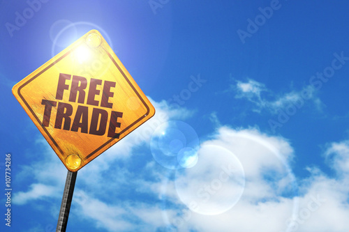 Cuadro en lienzo Yellow road sign with a blue sky and white clouds: free trade