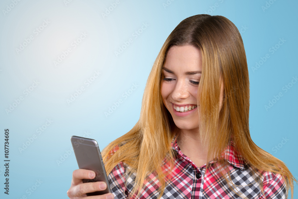 Cheerful young woman holding mobile phone Cheerful young woman holding mobile phone