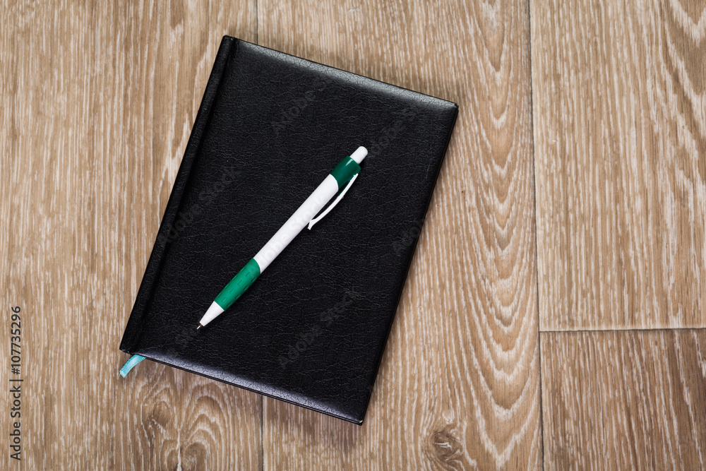Blank note paper with pen on wood background Blank note paper with pen on wood background