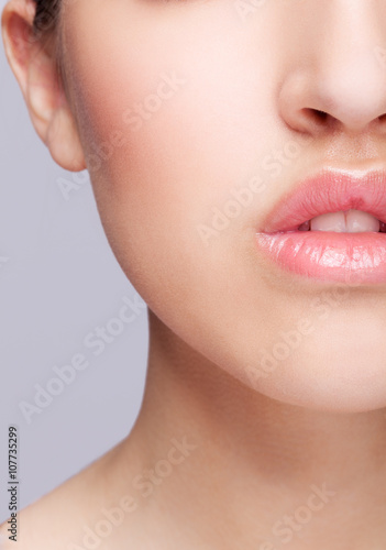 Half face female beauty portrait withrose color lips photo