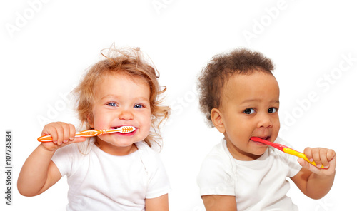 Black and white baby toddlers brushing teeth