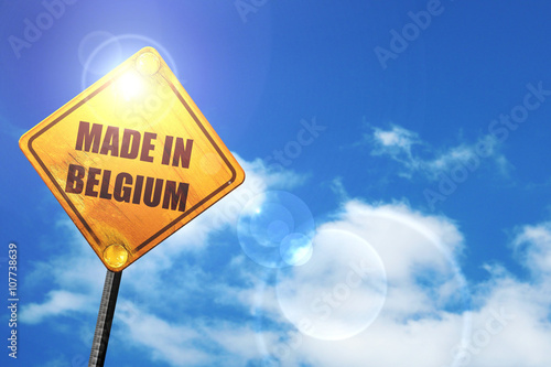 Yellow road sign with a blue sky and white clouds: Made in belgi photo