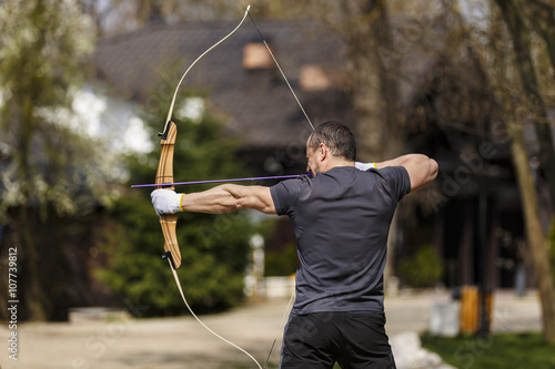 Man shooting with his bow at an outdoor range