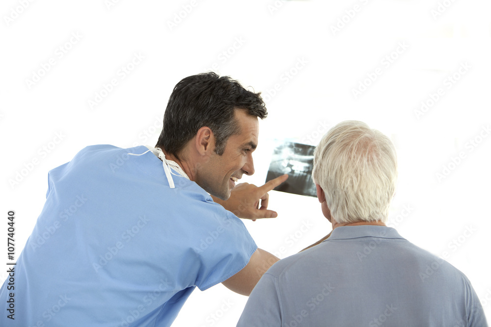 Doctor showing dental X-ray to senior patient Doctor showing dental X-ray to senior patient
