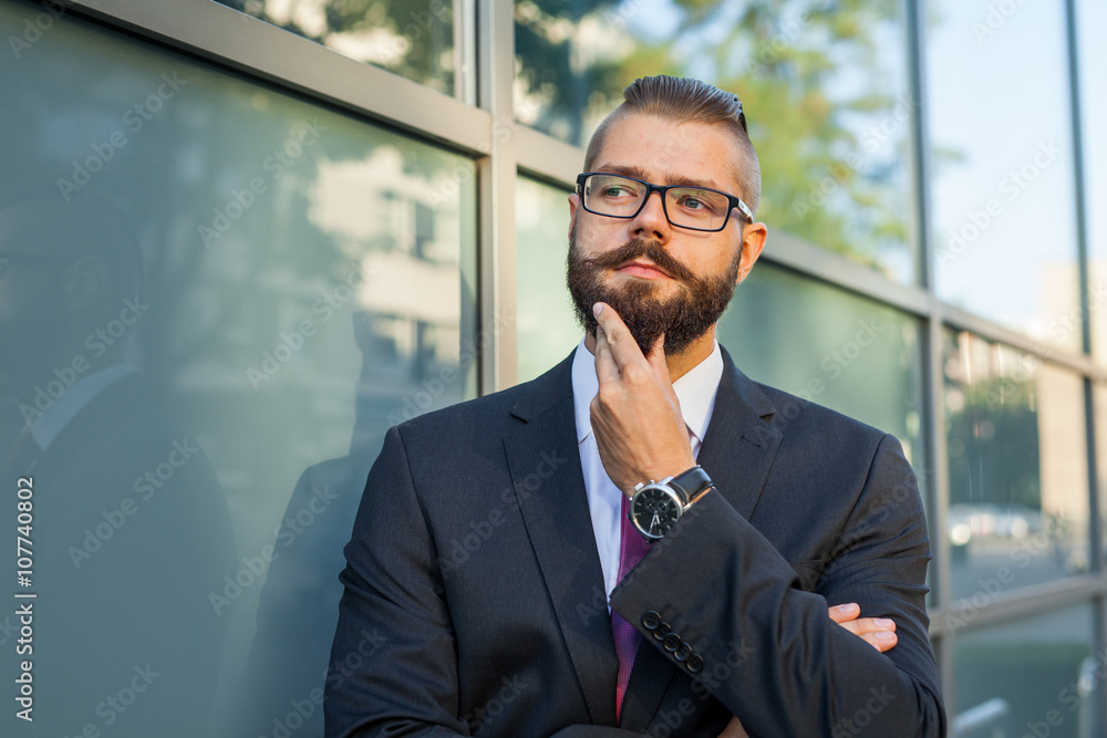 Young bearded businessman thinking abut plans for the weekend. Young bearded businessman thinking abut plans for the weekend.
