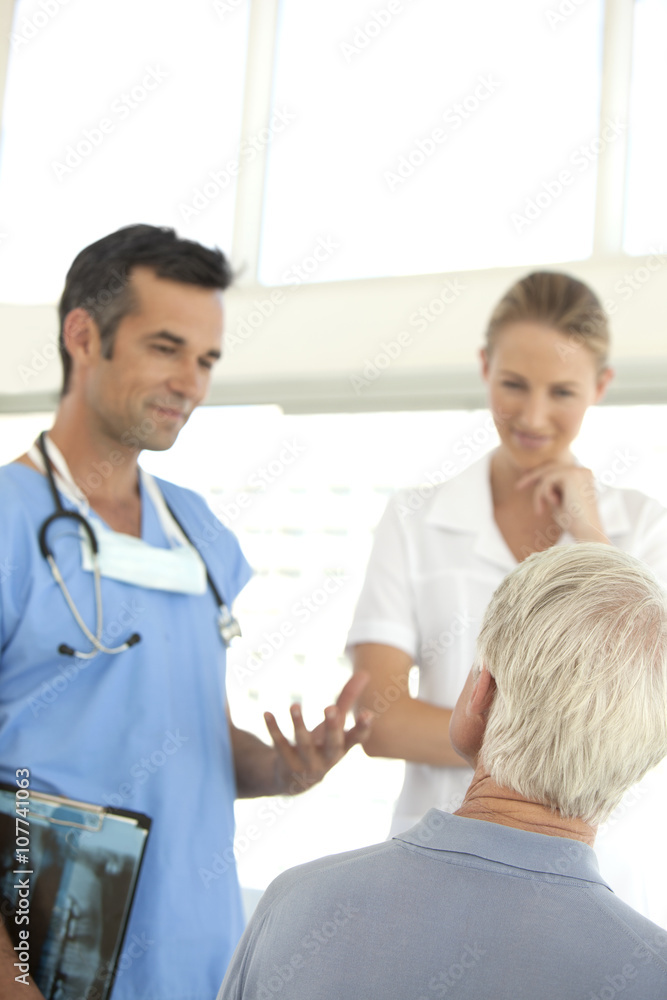 Doctor and nurse talking to senior patient at the hospital Doctor and nurse talking to senior patient at the hospital
