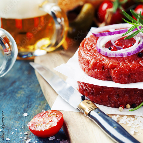 Beer and Raw Ground beef meat Burger steak cutlets with seasonin photo