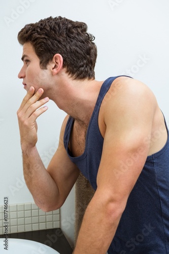 Man checking his stubble in bathroom