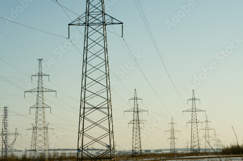 Electric power station lines, on the blue sky backing in the sunset