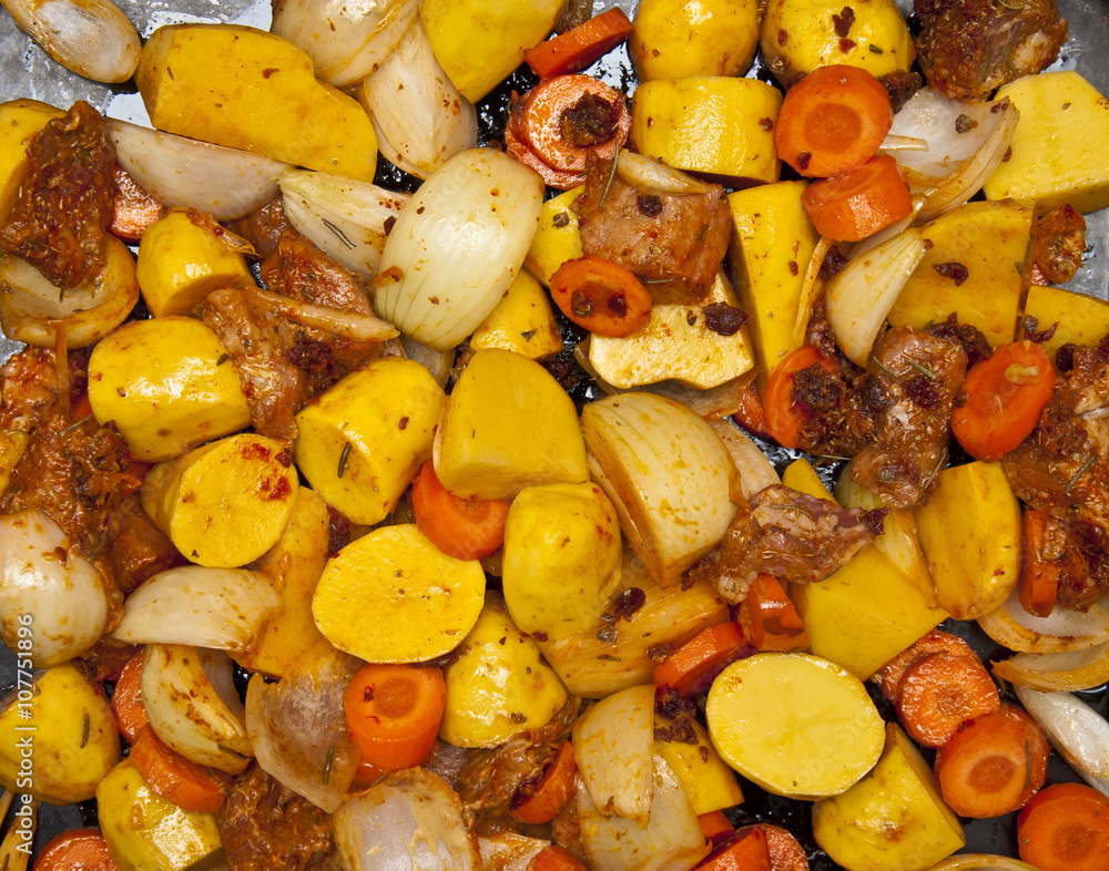 Mix of meat, potatoes, carrots, onion and marinade ready to bake Mix of meat, potatoes, carrots, onion and marinade ready to bake