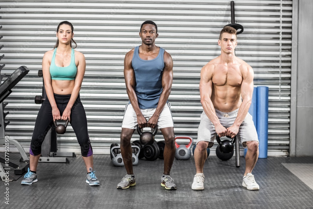 Fototapeta premium Fit people lifting dumbbells