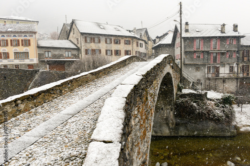 Roman bridge at Giornico onder snow on Leventina valley photo