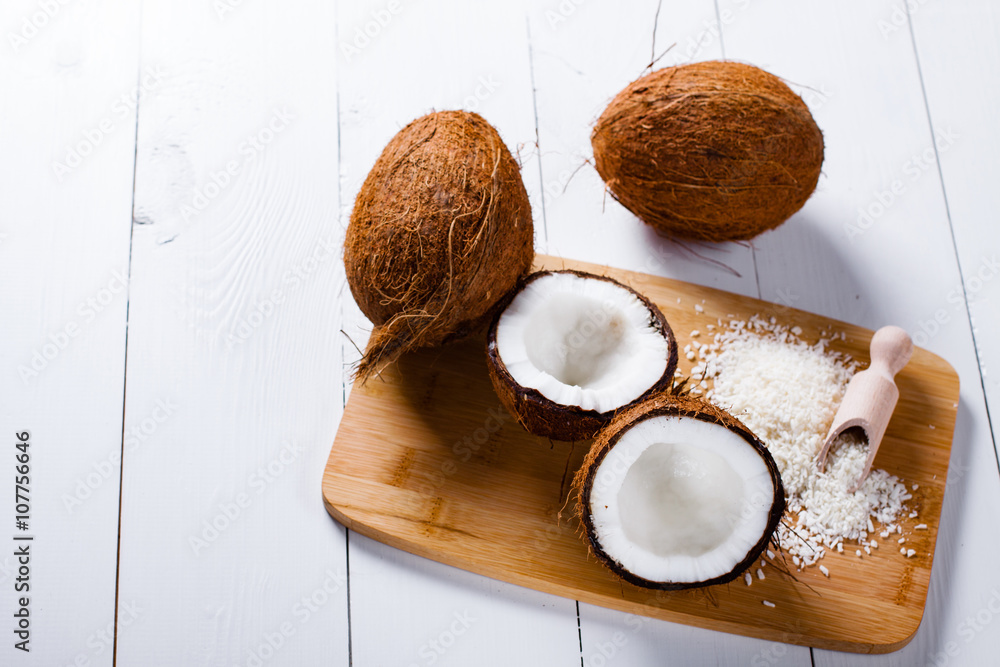 Whole and broken coconut with grated cocont flakes.