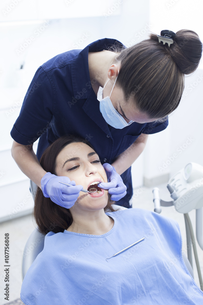Beautiful woman patient having dental treatment at dentist's office. Woman visiting her dentist Beautiful woman patient having dental treatment at dentist's office. Woman visiting her dentist