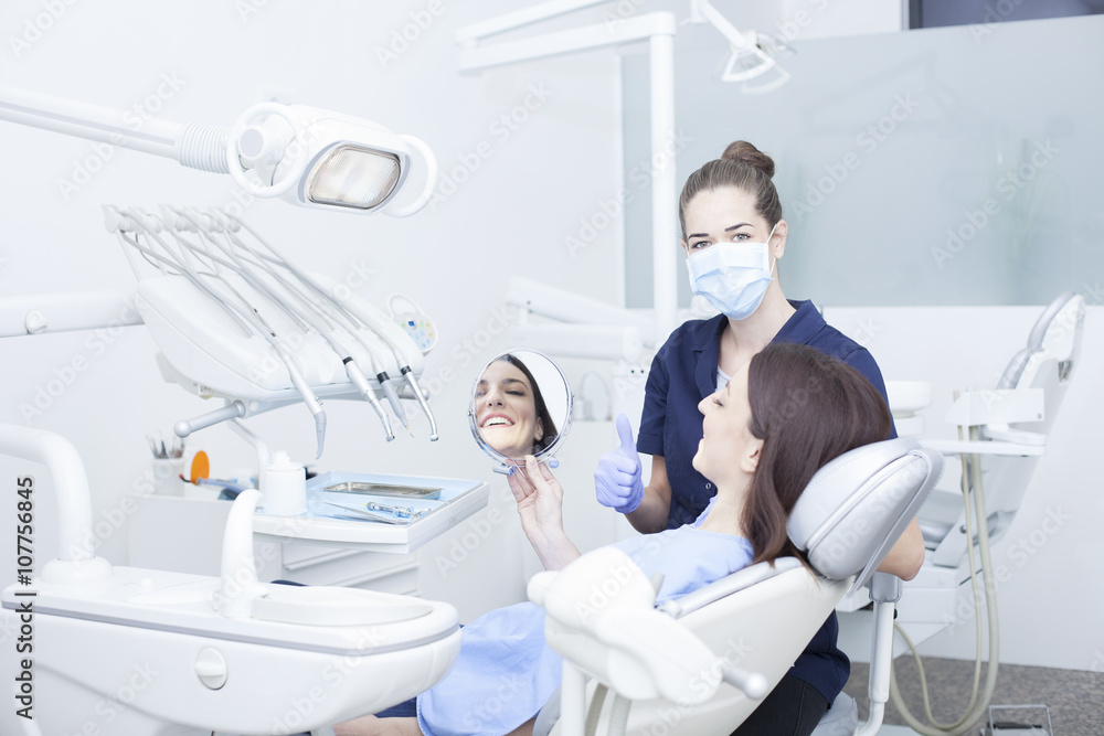 Obraz premium Beautiful woman patient having dental treatment at dentist's office. Woman visiting her dentist