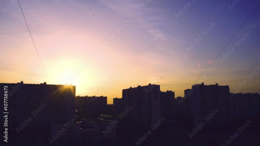 Sunset over the city with moving clouds and city lights time lapse Sunset over the city with moving clouds and city lights time lapse
