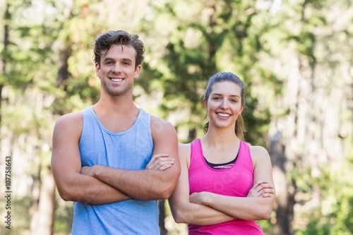 Portrait of smiling couple with arms crossed