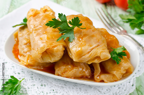Stuffed cabbage rolls with rice and meat on a white plate photo