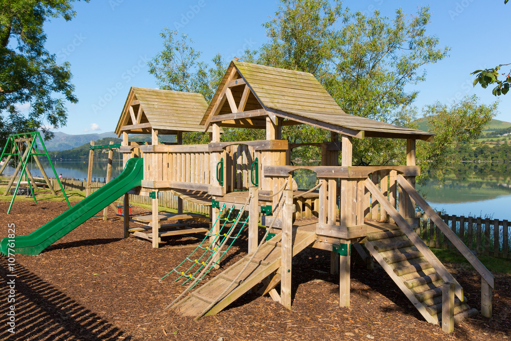 Wooden climbing frame for children in rural outdoor location by a lake Wooden climbing frame for children in rural outdoor location by a lake