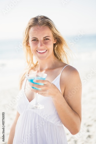 Blonde woman drinking cocktail