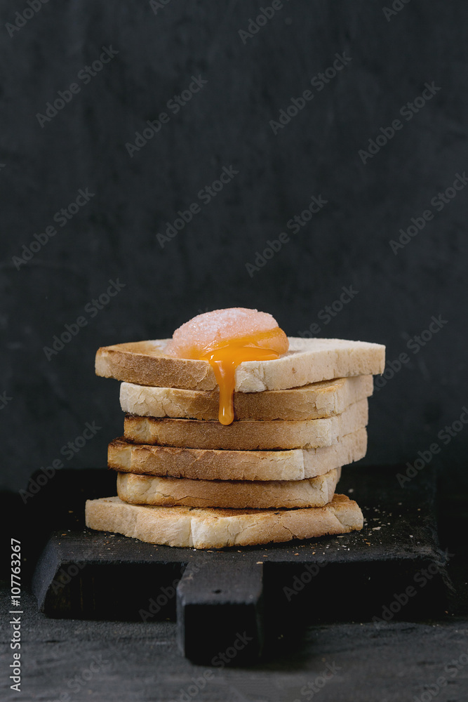 Toasts with yolk over black
