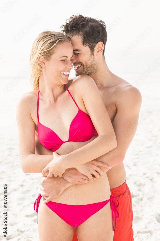 Happy couple embracing on the beach