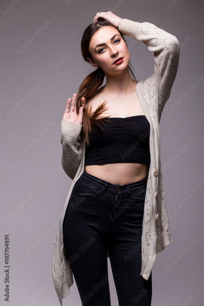portrait young elegant woman in black clothes and grey jacket. Fashion studio shot