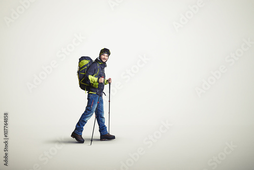 Man wear winter clothes with hiking poles