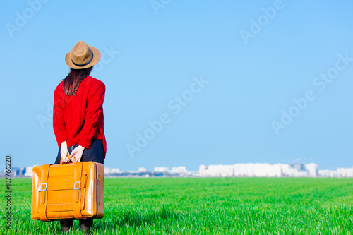 portrait of young woman with suitcase