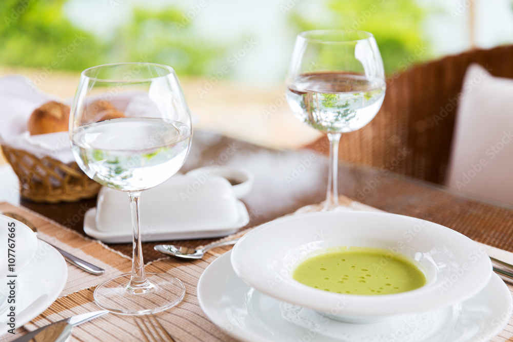 close up of soup and water glasses at restaurant close up of soup and water glasses at restaurant
