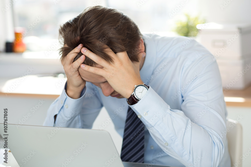 Tired businessman sitting at office Tired businessman sitting at office