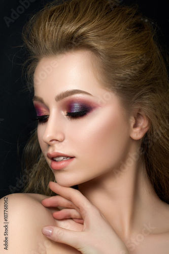 Close up portrait of young beautiful woman with fashion makeup