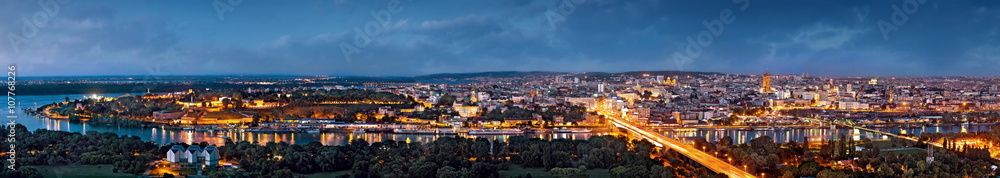 Belgrade panorama by night, Danube and Sava rivers confluence, city lights with blue cloudy sky