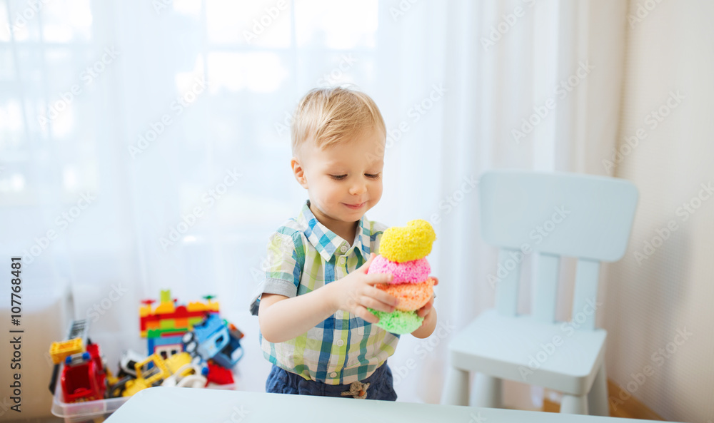 happy little baby boy with ball clay at home happy little baby boy with ball clay at home
